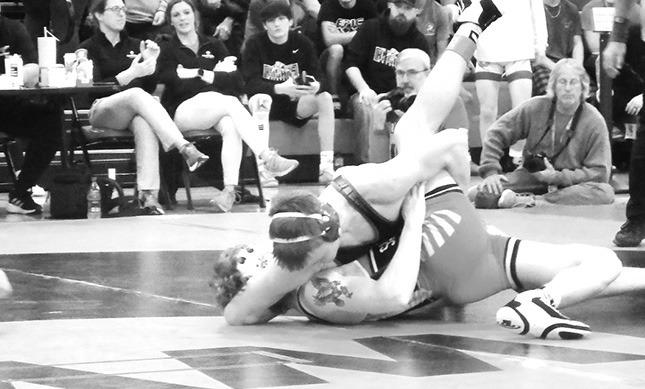 Dawson Mason goes for the pin in his district match Saturday.