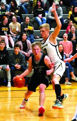 Trey Connell drives the baseline with Mullen defender Clayton Moore keeping close contact. (Courier photos by Loleta Connell)
