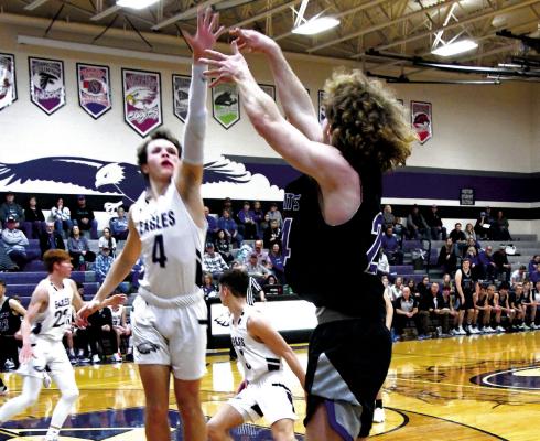 Harper Johnson makes his second 3-point shot of the night over Eagle senior Mitchel Wilson.