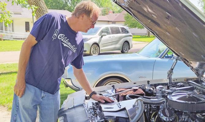 Lee Bruns looks under the hood of the 1979 Olds Cutlass he purchased brand new, and will display at Saturday’s car show in Callaway. Courier photo by Ellen Mortensen