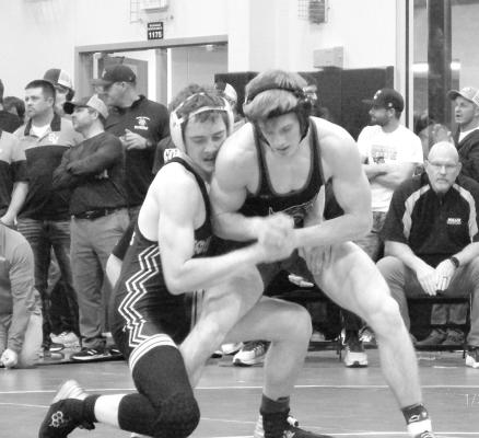 LEFT: Josiah Coleman works to get his opponent in position for a pin, which he accomplished on the Palmer wrestler. ABOVE: CJ Quandt earns points for an escape as he gets away from his opponent during a match in Greeley last Friday. Quandt went on to earn the 4th place medal at the invite. (Courier photos by Brandy Mason)