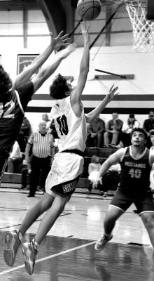 (Bottom Right) Freshman Dylan Pandorf gets a step ahead of the Mustang defenders to lay it in for two.