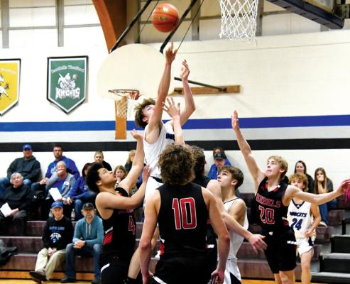 Junior Cache Gracey weaves through numerous Arcadia/Loup City defenders Tuesday night in Callaway.