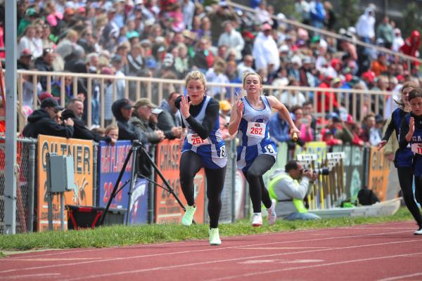 Bryn Schwarz and Taylor Ross execute a solid handoff during the 4 x 100 meter relay. (Photo courtesy of Callam Sports Photography)