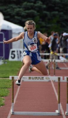 Charli Vickers clears a hurdle down the stretch of the Class C 300 meter hurdles. (Courier photo by Corbey Dorsey)