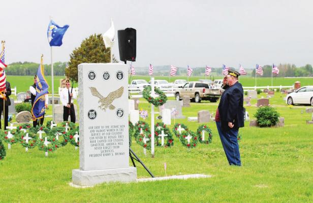 Dirk Stryker of the Callaway American Legion salutes after laying the memorial wreath during the program at Rose Hill Cemetery on Monday(Courier photo by Amanda Koubek Wehnes)