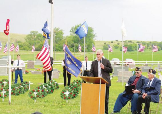 TOP RIGHT: Pastor and Veteran Bill Williams speaks during the Memorial Day ceremony at Rose Hill Cemetery on Monday.