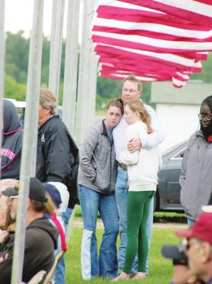 LEFT: Duane Kimball embraces his daughters Lucy and Emily during the Callaway Memorial Day program at Rose HIll Cemetery on Monday. (Courier photos by Amanda Koubek Wehnes)