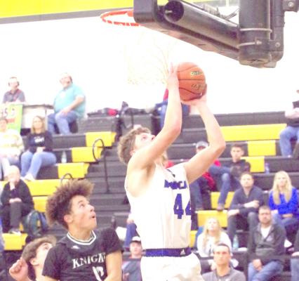 Crew Witthuhn takes the ball all the way to the bucket for the Bobcats against Sandhills-Thedford during a conference game in North Platte on Saturday. (Courier photo by Ronda McFate)
