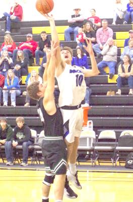 LEFT: Dylan Pandorf goes over the top of a Sandhills-Thedford defender for a basket during their conference match-up on Saturday.