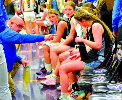 Coach Bryon Hanson gives instructions during Tuesday night's sub district game against Southern Valley. (Courier photo by Patti Schwarz)