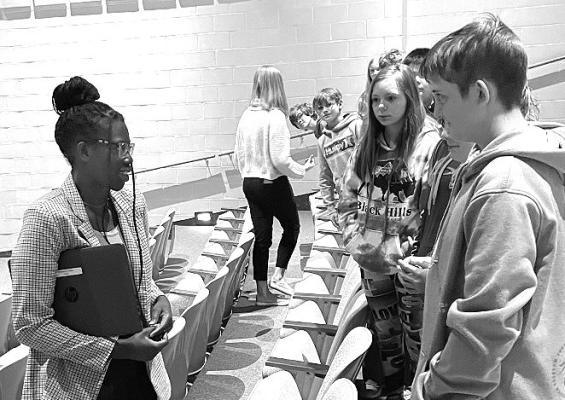 Nadeema Haidle takes a moment to talk with fellow CHS students following her Senior College Prep class presentation last week.