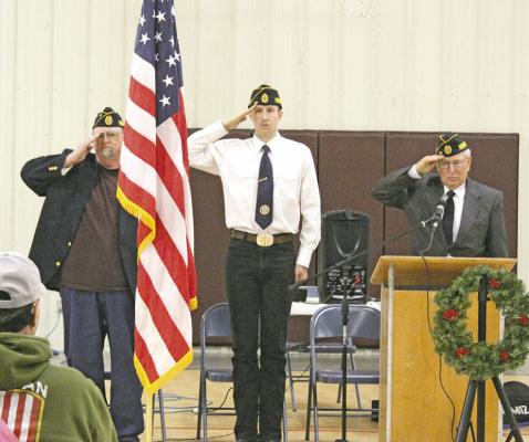 Everyone stood silently at attention as TAPS was played from the back of the Callaway Community Center at Monday's Memorial Day program. (Courier photo by Ellen Mortensen)