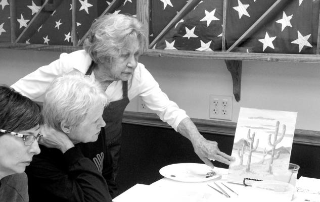 Artist Mariel Klingbeil gives painting tips to Tami Smith during a painting class at the Callaway American Legion hall. The classes are held the second and fourth Tuesday of each month. (Courier photo by Ellen Mortensen)