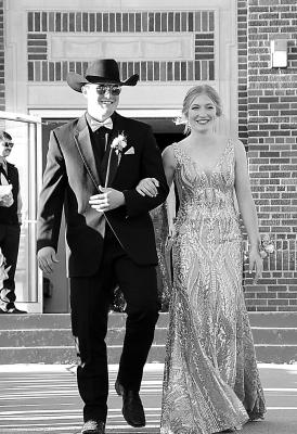 Abby Stallbaumer and Rio Remund walk in the Grand March on Saturday at the South Loup Prom in Arnold.