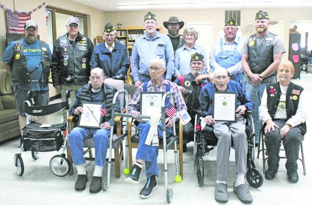 Members of the Sandhills Chapter of American Legion Riders presented certificates and flags to veterans pictured in the front row, from left, Claude Rhoads, Jimmie Kennedy, and Bill Benjamin. BELOW
