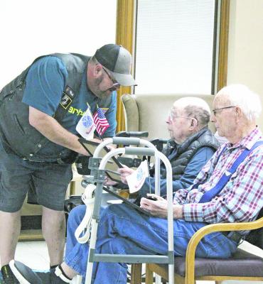 A member of the Legion Riders presents a certificate to Army veteran Claude Rhoads at Callaway Good Life Center on Sunday, as fellow veteran and CGLC resident Jimmie Kennedy looks on. (Courier photos by Ellen Mortensen