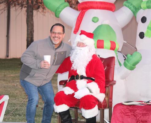 Henry Moore took advantage of a time when Santa had no children visiting to pop in and say hi to the big guy and get his own photo taken. The Callaway Old Fashioned Christmas is a fun holiday event for all ages. (Courier photo by Ellen Mortensen)
