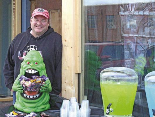 Adam Bailey greeted trunk-or-treaters with his Ghostbusters themed display in front of the former Masonic building.