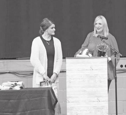 Volleyball coach Desiree Guthrie watches as retiring coach Kim Sallach addresses the crowd at the South Loup sports banquet on May 6. (Courier photos by Amanda Koubek - Wehnes)