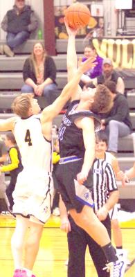 Crew Witthuhn soars above his opponent to get the ball. Witthuhn led the Bobcats in scoring and rebounds this season, and will be back next year. (Courier photos by Ronda McFate)
