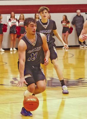 Conner Paulsen brings the ball up the court for the Bobcats with teammate Hudson Vickers in the background.