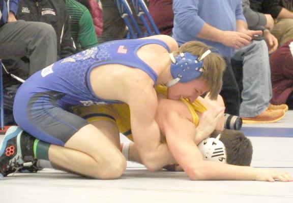 Dawson Mason gets on top of his opponent as he works to get him to the mat during a match at the district tournament this past weekend. Mason was crowned district champion at 132 pounds. (Courier photo by Brandy Mason)
