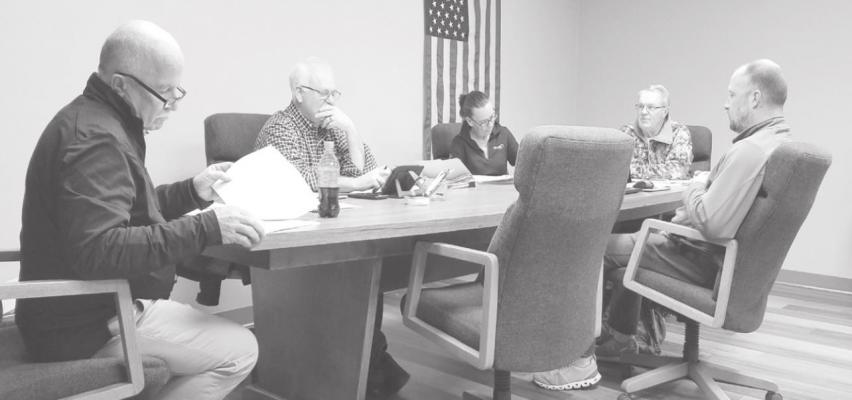 From left, Village Board members Ken Pitkin, Lawrence Paulsen, Village Clerk Lori Bonde, Mark Kimball and Abe Hinman discuss issues during the March 8 board meeting. Board member Dan Lewandowski was absent.
