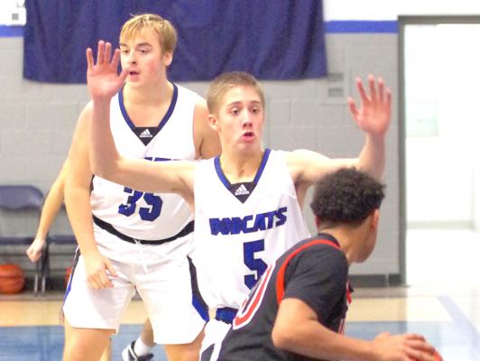 Callen Witthuhn (#5) tries to block a Maxwell player from getting to the basket. (Courier photo by Ronda McFate)