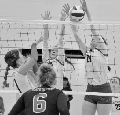 Delaynie Laible and Delaney Rogers block an attempted Anselmo- Merna kill.