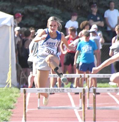 ABOVE: Charli Vickers makes her way down the track in the 300m hurdles.