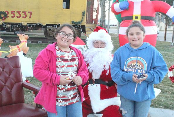 Kinsley, left, and Brooklyn took an opportunity to visit with Santa in the mini-park in downtown Callaway on Dec. 4 to share their wish list. (Courier photos by Ellen Mortensen)