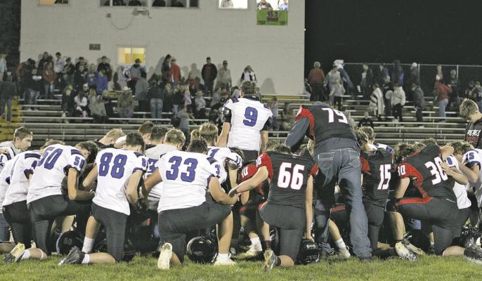 The Bobcats and Rebels met on the field following the Oct. 16 game and shared a moment of prayer. Photo courtesy EvaLynn Wonch