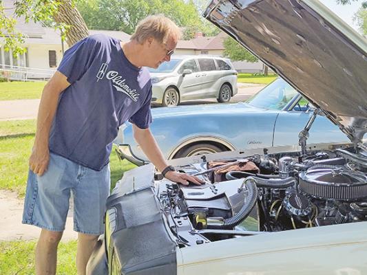 Lee Bruns looks under the hood of the 1979 Olds Cutlass he purchased brand new, and will display at Saturday’s car show in Callaway.