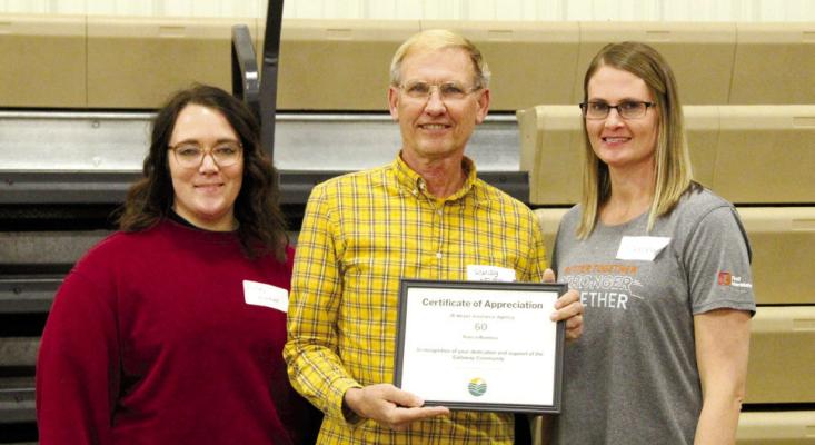 Randy Meyer accepted the certificate for 60 years of business in Callaway from Chamber board members Kelsey Wyckoff, left, and Stacey Guthard.