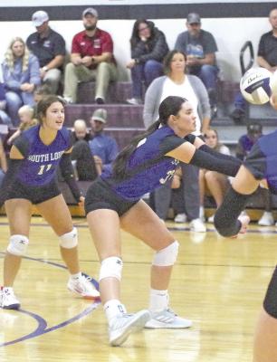 ABOVE: Aubrey Birkel receives the ball as teammate Addie Stump encourages her from the background as South Loup took on Hi-Line on Sept. 5 at home. LEFT: South Loup's Emma Stallbaumer goes up for the block against Hi-Line last week in a hard fought match. (Courier photos by Ronda McFate)
