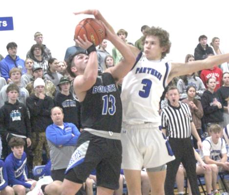 Connor Paulsen faces some tough defense from the Hershey Panthers as he attempts a shot on Jan. 7. Paulsen finished the game with 12 points in helping the Bobcats to a victory. (Courier photos by Ronda McFate)