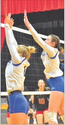 Addison Stump and Delaney Rogers get a good block during the Triangular Vs. Merna on Aug. 29. (Photo courtesy Patti Schwarz)