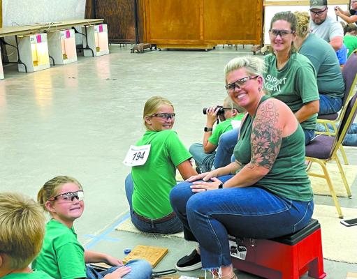 Western Riders 4-Hers Ruby Hagler and Claire Kulp pose for a photo between shooting rounds, with their moms Heather Hagler and Heidi Kulp. (Photo courtesy Heather Hagler)