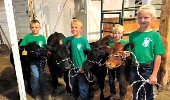 These hard-working kiddos were ready and waiting in line to be interviewed for their bucket calves. From left are Kowen Dalrymple, Brody Blowers, Reese Hagler, and Quinlee Weinman. (Photo courtesy Katie Weinman)