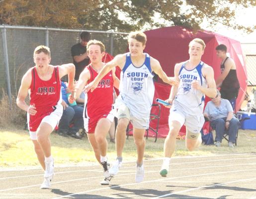 Ethan Furne hands the baton off to Dylan Pandorf in the boy's 4x100m Relay last week in Loup City. The team earned the silver medal in the event. (Courier photos by Ronda McFate)