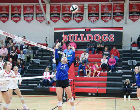 Ava Pandorf sets the ball against Ainsworth last Tuesday. The Bobcats beat the Bulldogs 3-1 in the final game of the regular season. Photo by Amanda Wehnes