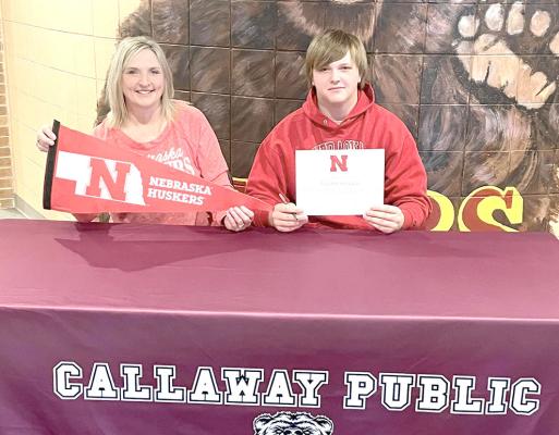 Joey Sallach is joined by his mom, Kim, as he signs his letter of intent to attend the University of Nebraska at Lincoln to study agribusiness. (Photo courtesy CPS)
