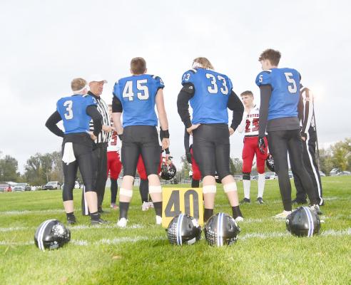 Meeting at the 40-yard line for the Captain's meeting in their last regular season game are Bobcat Seniors: Trey Connell, Rio Remund, Joey Sallach, and Cache Gracey.