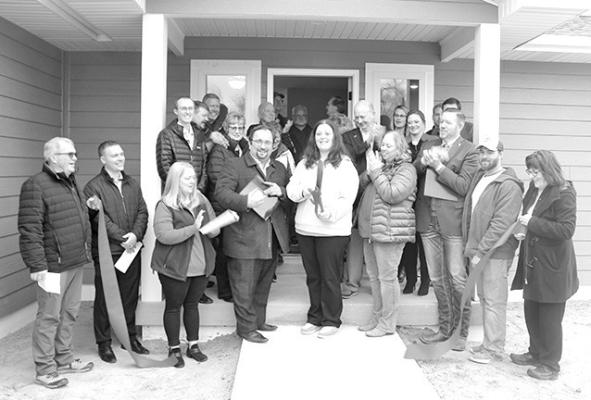 Judy Peterson of the Central Nebraska Economic Development District cuts the ribbon on a new home in Callaway that was constructed using funds from the Nebraska Affordable Housing Trust Fund.