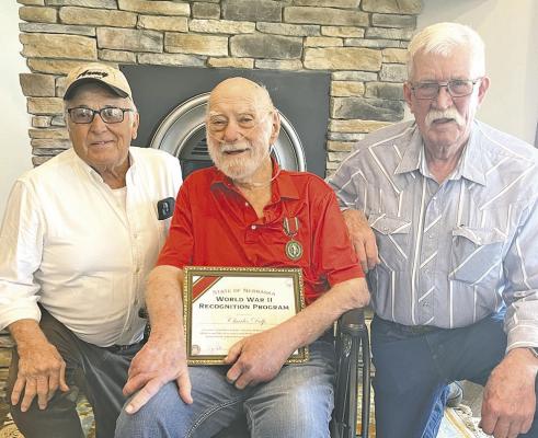 Gary Mills, left, and Dave Chesley, right, presented a certificate and medal to World War II veteran Charles Delp in honor of the 80th anniversary of the end of WWII. (Photo courtesy Jo Chesley)