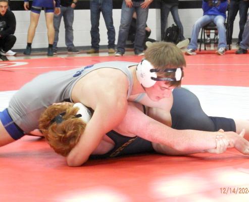 CJ Quandt won the silver medal at 157 pounds at the Anselmo-Merna Invite held Dec. 14. Here Quandt is getting a pin on one of his opponents. He was one of three Bobcat wrestlers to medal at the tournament. (Courier photo by Brandy Mason)