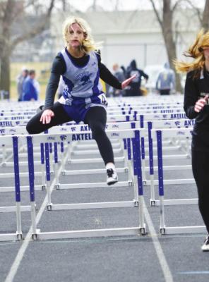 (Left) Charli Vickers clears the final hurdle in the 100 meter high hurdles prelims on April 19 at Overton. Vickers qualified for the finals in the event, taking the bronze. (Courier photos by Jessica Tickle)
