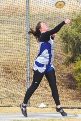 (Above) Riata Remund braved the wind for a 78'4" throw in Axtell Tuesday. (Courier photo by Loleta Connell)