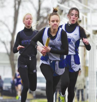 (Right) Heidi Donegan gets out quickly after receiving the baton from Talliana Martin in the 3200 meter relay. Donegan and Martin teamed up with Ella Cool and Ivy Tulis for gold in the event with a time of 14:03.51. (Courier photos by Jessica Tickle)
